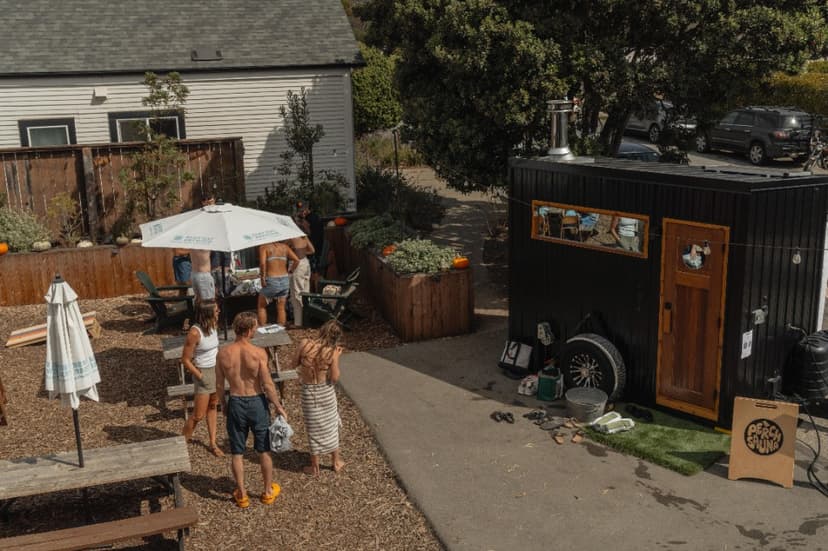 Guests gathered in the courtyard next to the black Perch Sauna trailer at the Davenport Roadhouse